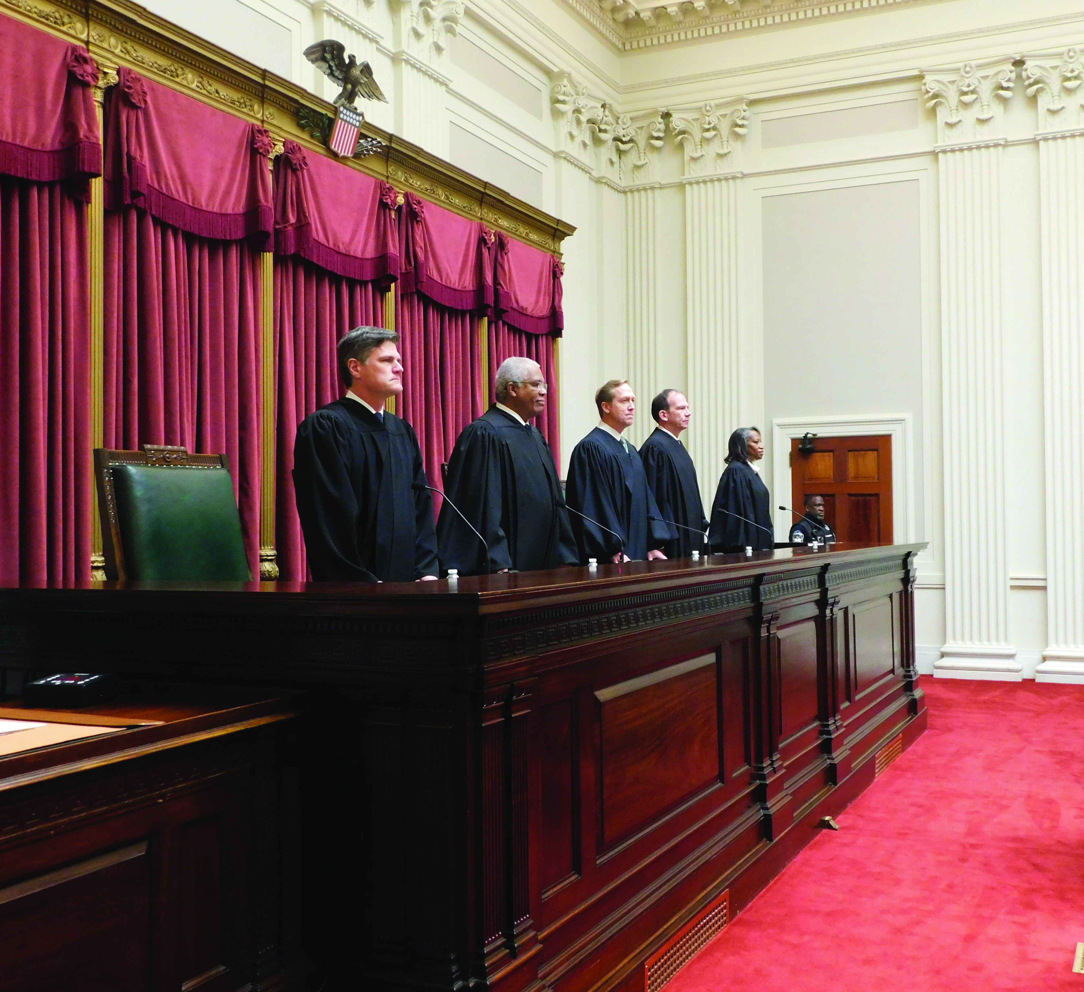 The judges of the U.S. Court of Appeals for the Armed Forces prepare to take the bench for the admissions ceremony of the 72d Graduate Course. From left to right: Judge Liam P. Hardy, Judge John E. Sparks, Chief Judge Kevin A. Ohlson, Judge Gregory E. Maggs, Judge M. Tia Johnson. (Credit: Lanell A. Best) 